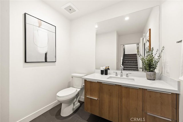 bathroom with toilet, tile patterned flooring, and vanity