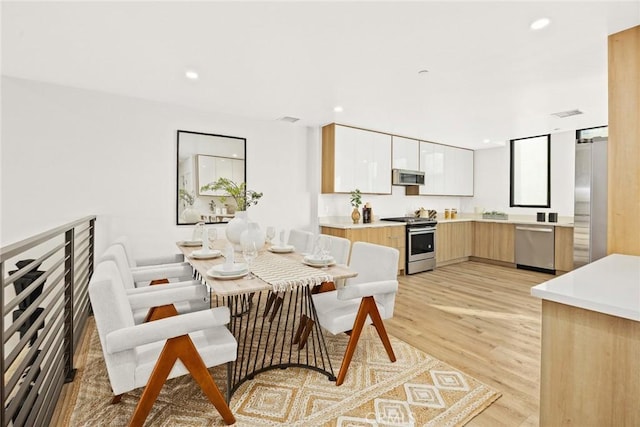 dining space with light wood-type flooring