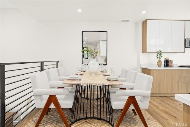 dining area with light hardwood / wood-style floors