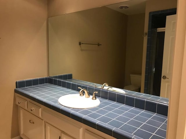 bathroom with toilet and vanity