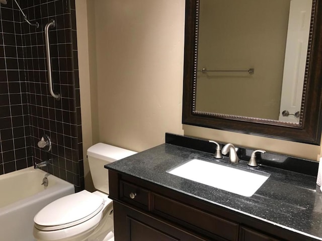 full bathroom with toilet, vanity, and tiled shower / bath