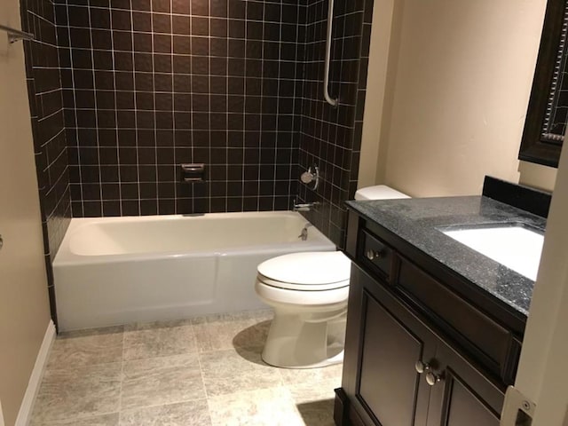 full bathroom with toilet, vanity, and tiled shower / bath