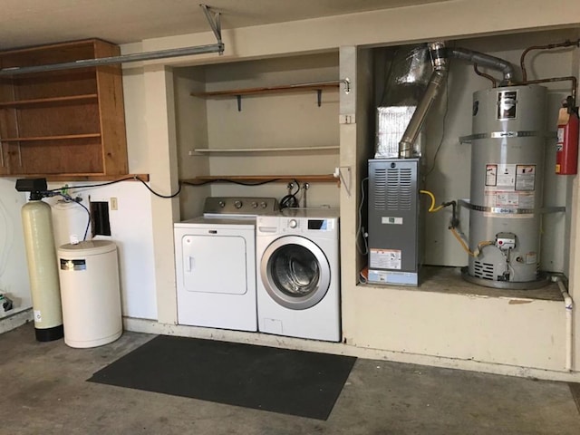 laundry room with washer and clothes dryer and strapped water heater