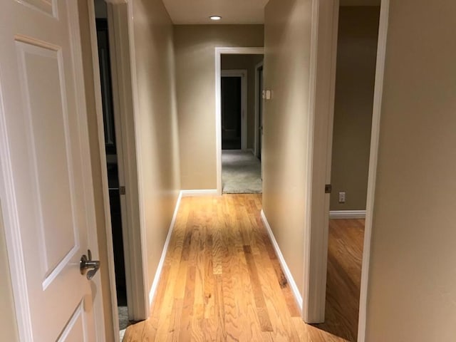 hallway with light hardwood / wood-style flooring