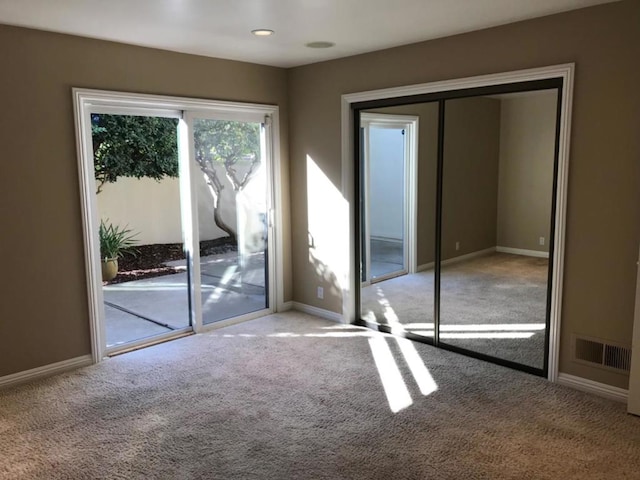 spare room featuring light colored carpet