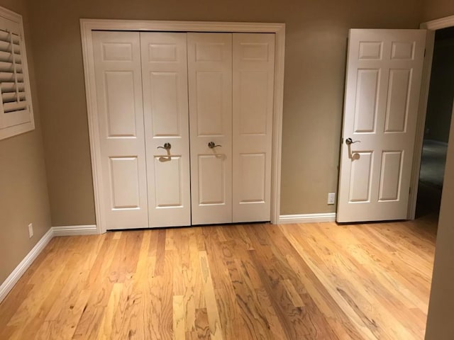 unfurnished bedroom featuring a closet and light hardwood / wood-style flooring