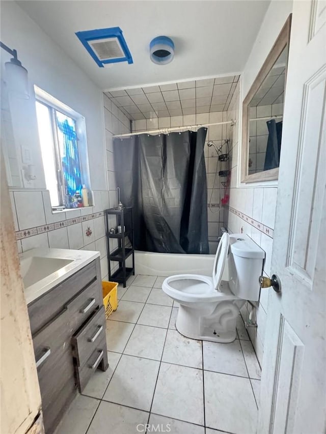 full bathroom with toilet, tile walls, tile patterned floors, and shower / bathtub combination with curtain