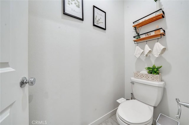 bathroom with toilet and tile patterned flooring