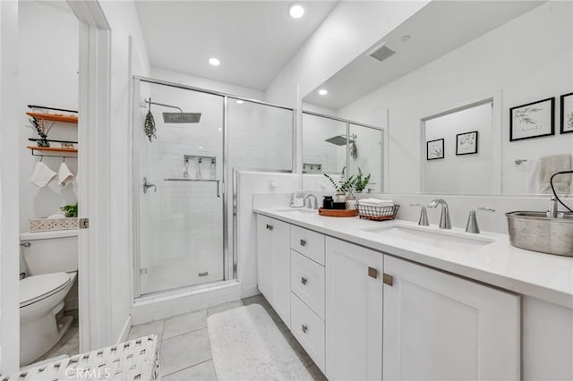 bathroom featuring a shower with shower door, tile patterned floors, toilet, and vanity