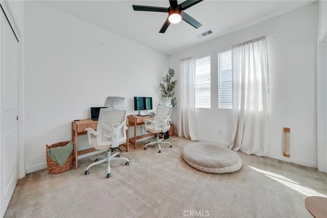 carpeted home office with ceiling fan