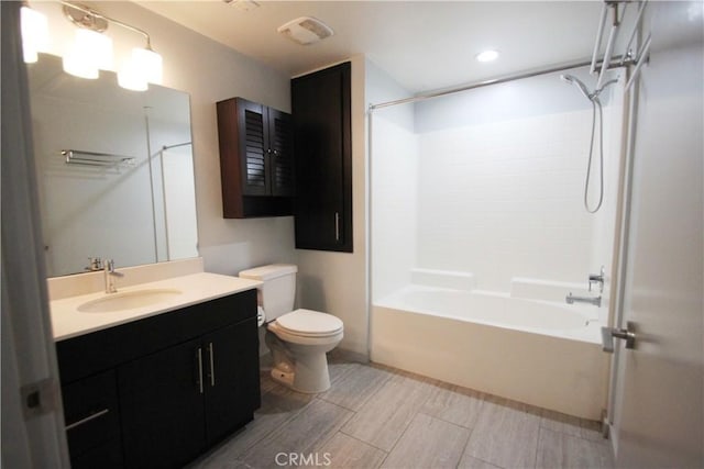 full bathroom with toilet, vanity, and shower / washtub combination