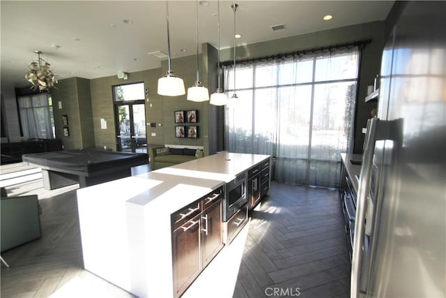 kitchen featuring hanging light fixtures, pool table, parquet floors, and a chandelier