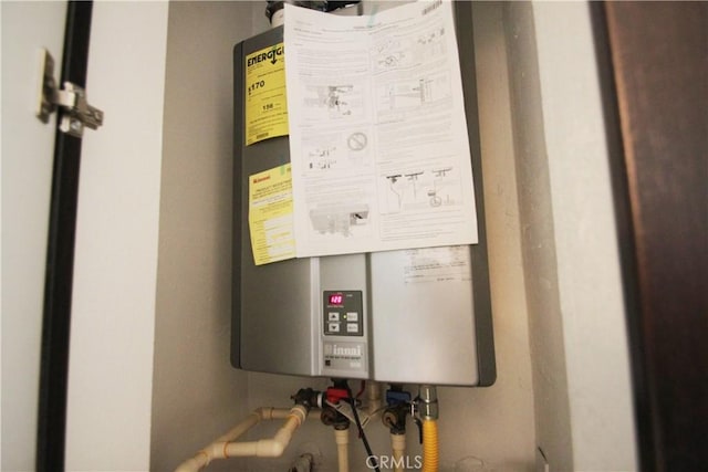 utility room featuring tankless water heater