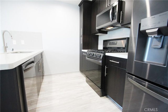 kitchen featuring backsplash, appliances with stainless steel finishes, and sink