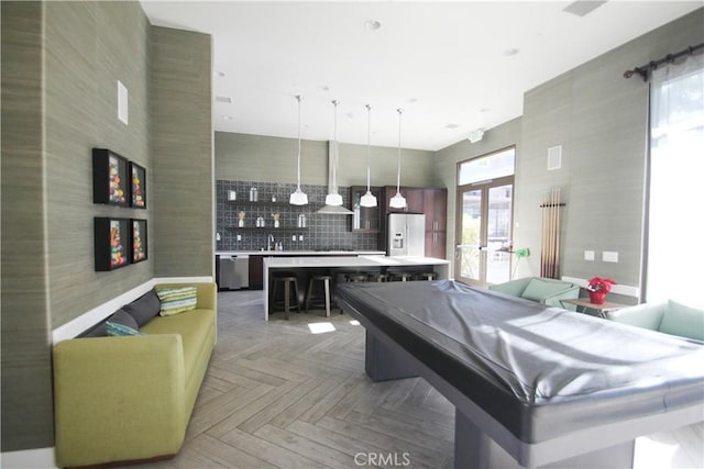 game room featuring parquet flooring, pool table, a high ceiling, french doors, and sink