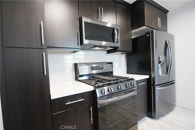 kitchen with decorative backsplash, appliances with stainless steel finishes, and dark brown cabinets