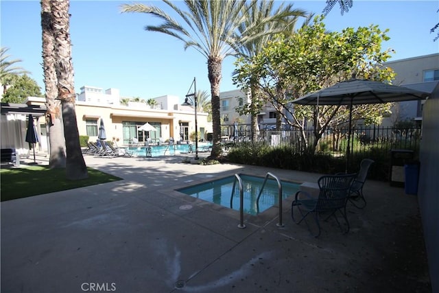 view of pool with a hot tub