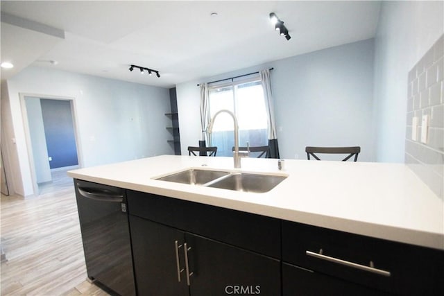 kitchen with track lighting, black dishwasher, light hardwood / wood-style floors, and sink