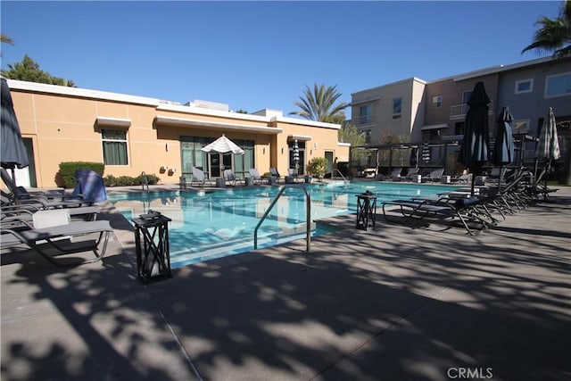 view of swimming pool featuring a patio area