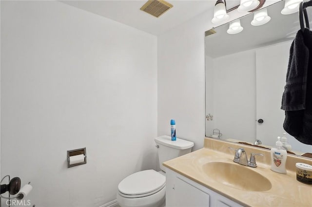 bathroom with toilet and vanity