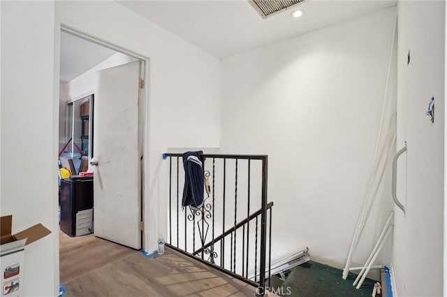 hallway with light hardwood / wood-style floors