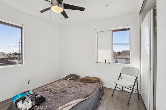 bedroom with ceiling fan and light wood-type flooring