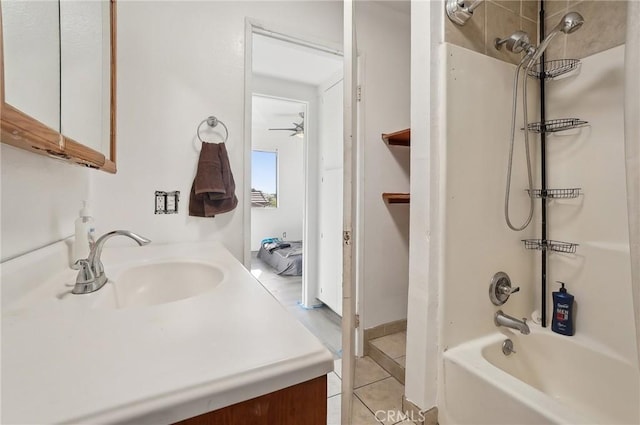 bathroom with shower / bathing tub combination, ceiling fan, tile patterned floors, and vanity