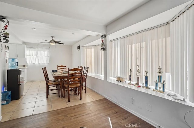 dining space with light tile patterned flooring and ceiling fan