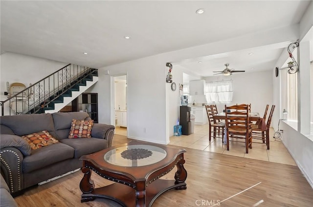 living room featuring ceiling fan and light hardwood / wood-style flooring