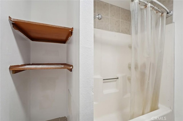 bathroom with shower / bath combo with shower curtain