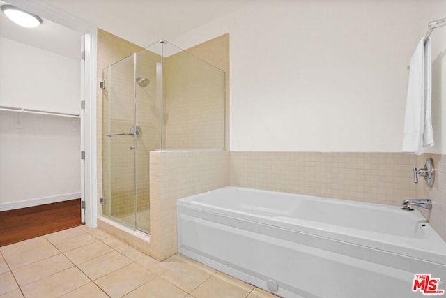 bathroom featuring tile patterned flooring and independent shower and bath