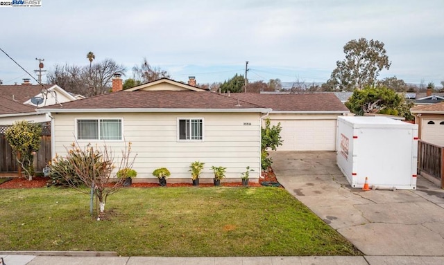 view of front of home with a front yard and a garage