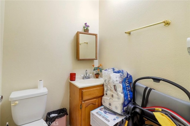 bathroom featuring toilet and vanity