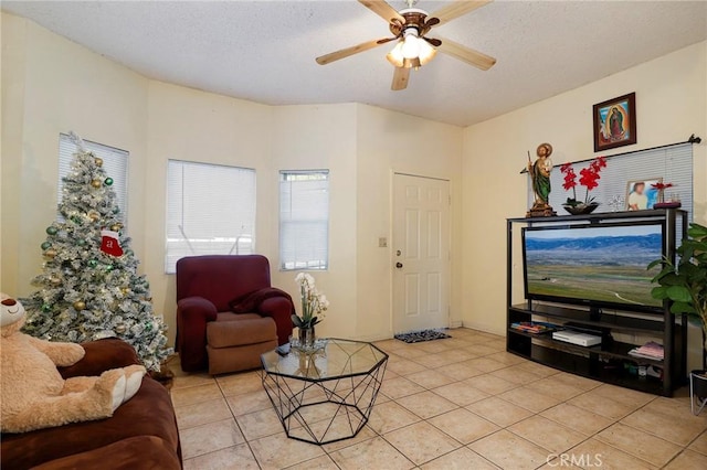 tiled living room with ceiling fan