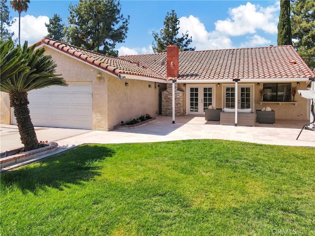 exterior space featuring a garage, a front yard, and an outdoor living space