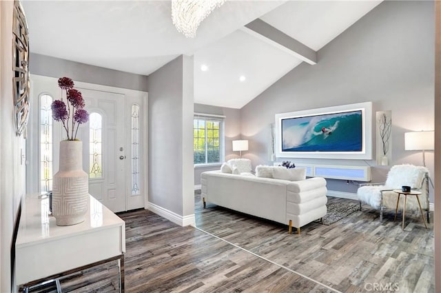 living room with hardwood / wood-style flooring, lofted ceiling with beams, and an inviting chandelier