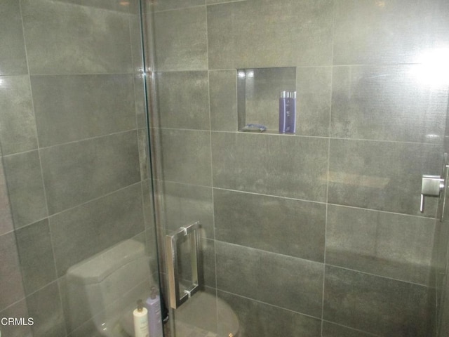 bathroom with a shower with door