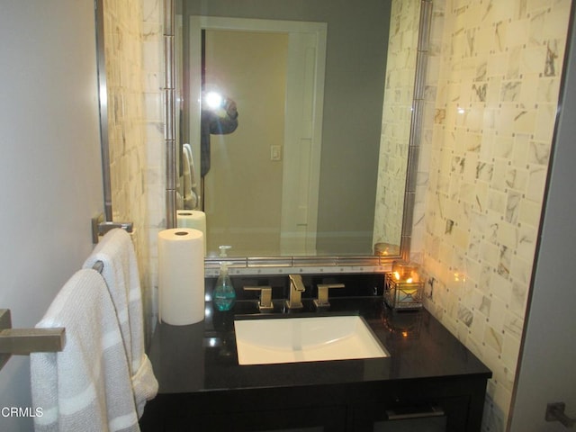 bathroom featuring vanity and tasteful backsplash