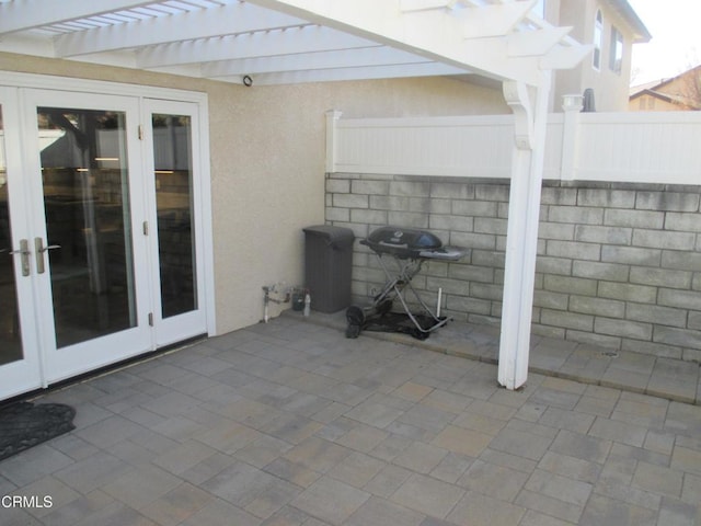 view of patio featuring a grill, french doors, and a pergola