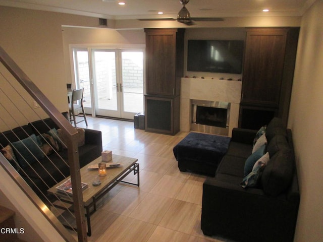 living room with ceiling fan, ornamental molding, and french doors