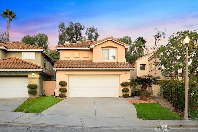 mediterranean / spanish home featuring a garage