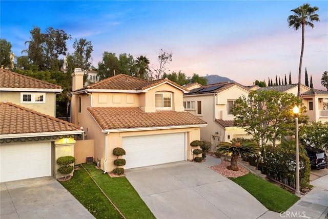 mediterranean / spanish-style house with a garage