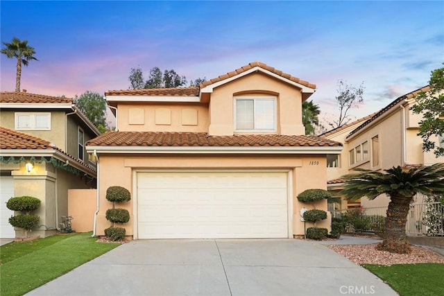 mediterranean / spanish-style house with a garage