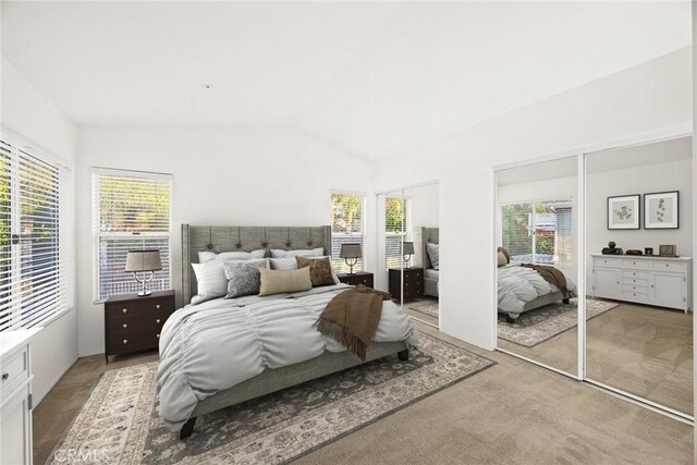 carpeted bedroom with vaulted ceiling