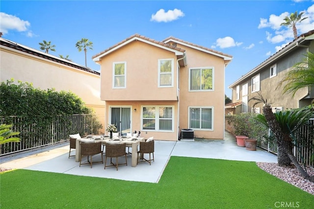 rear view of house with central AC unit, a lawn, and a patio