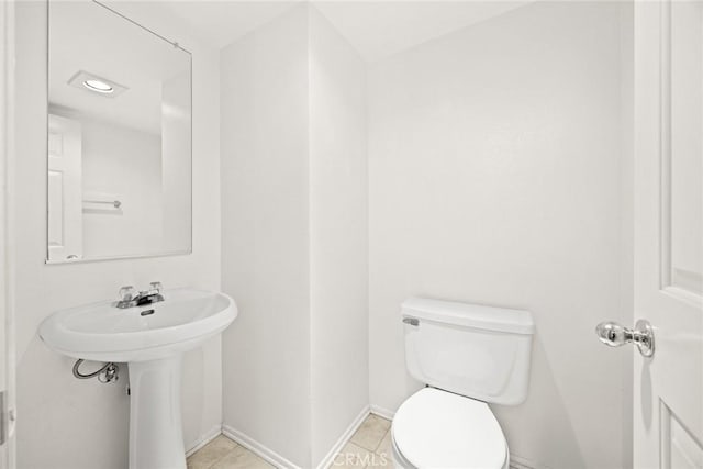 bathroom featuring toilet and tile patterned flooring