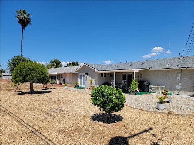 back of property with a patio