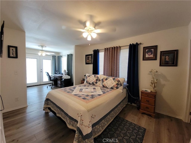 bedroom with ceiling fan, multiple windows, dark hardwood / wood-style floors, and french doors