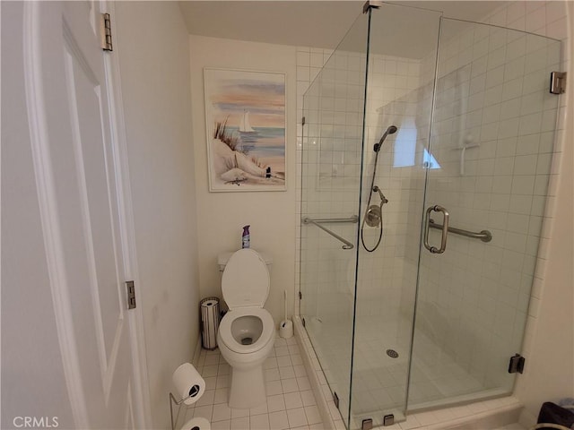 bathroom with toilet, tile patterned flooring, and a shower with shower door