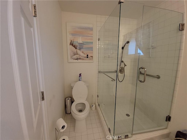 bathroom with toilet, tile patterned flooring, and a shower with door